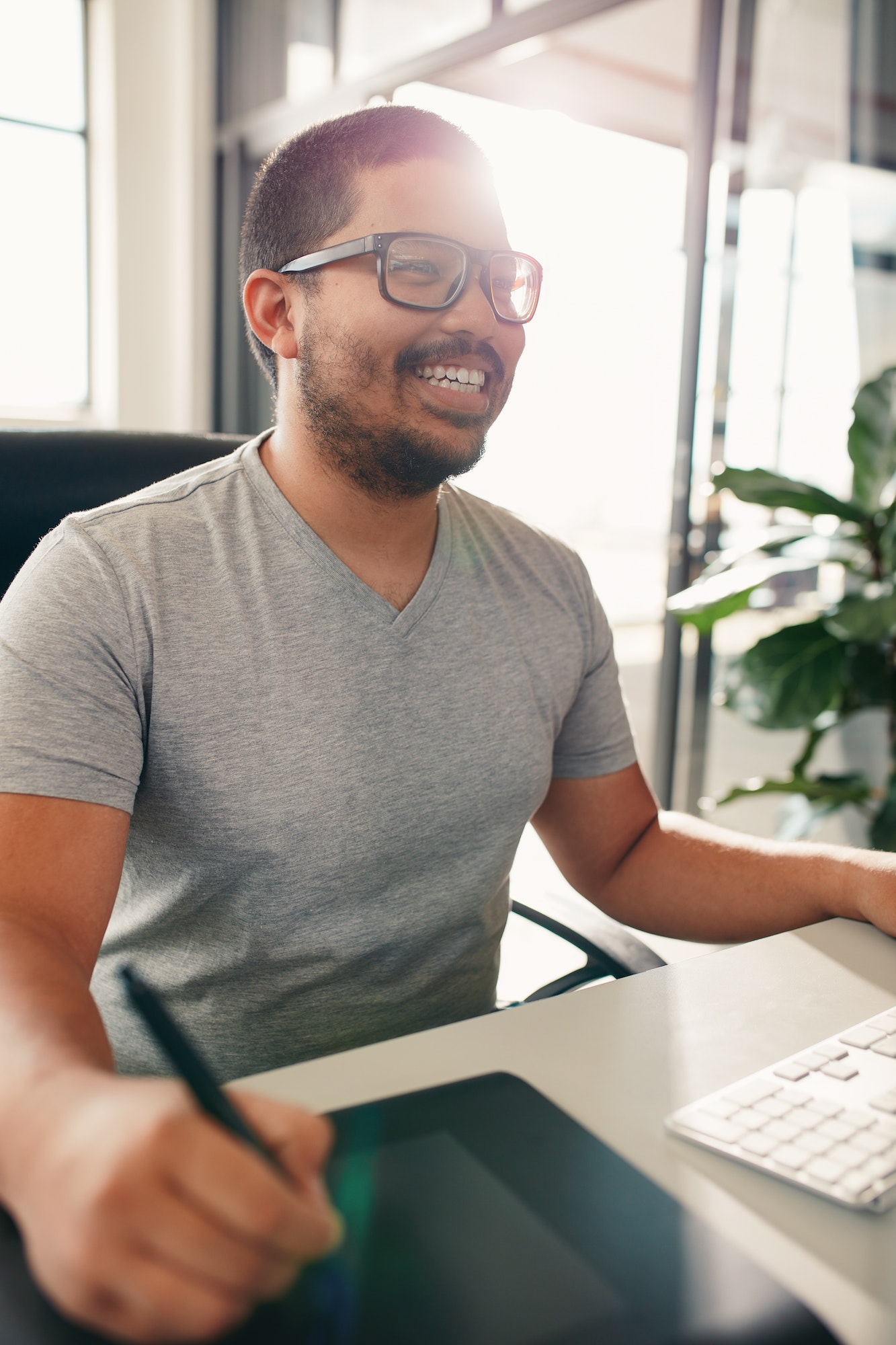 Happy graphic designer working in his office